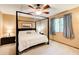 Bedroom with a four-poster bed, ceiling fan, and neutral carpeting, creating a relaxing atmosphere at 8531 Lake Dr, Snellville, GA 30039