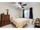 Cozy bedroom with neutral tones, ceiling fan, a window and a decorative dresser at 8531 Lake Dr, Snellville, GA 30039