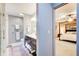 View from the bathroom into a Primary bedroom with four-poster bed and ceiling fan at 8531 Lake Dr, Snellville, GA 30039