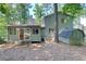 Back exterior view of home showcasing siding, shed, windows, door and wooded lot at 8531 Lake Dr, Snellville, GA 30039