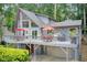 Exterior view of a home with large deck, outdoor furniture, and wooded surroundings at 8531 Lake Dr, Snellville, GA 30039