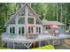 Charming exterior view of the home with a spacious deck and lush surroundings at 8531 Lake Dr, Snellville, GA 30039