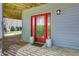 A charming red front door with sidelights is visible, complete with decorative porch decor at 8531 Lake Dr, Snellville, GA 30039