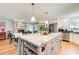 Eat-in kitchen with dining table and chairs, white cabinets, granite counters, and stainless steel appliances at 8531 Lake Dr, Snellville, GA 30039