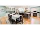 An open kitchen with white cabinetry and granite countertops connects to an elegant dining area at 8531 Lake Dr, Snellville, GA 30039