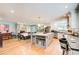 Open concept kitchen with granite counters, white cabinets, stainless steel appliances, and an eat-in dining table at 8531 Lake Dr, Snellville, GA 30039