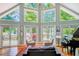 Bright living room with high ceilings, large windows, and access to the deck at 8531 Lake Dr, Snellville, GA 30039