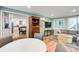 The living room has wood floors and light green walls with a view of the modern white kitchen with an island at 8531 Lake Dr, Snellville, GA 30039