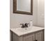Bathroom featuring a gray vanity with black hardware and a decorative mirror at 1126 Village Ct, Atlanta, GA 30316