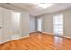 Bedroom with hardwood floors, ceiling fan, access to the back, and ensuite bathroom at 1126 Village Ct, Atlanta, GA 30316