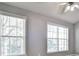 Bedroom featuring neutral walls, two windows with blinds, and a ceiling fan at 1126 Village Ct, Atlanta, GA 30316