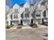 Attractive townhomes with garages and dark blue doors, trimmed with shrubs at 1126 Village Ct, Atlanta, GA 30316