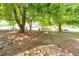 Backyard featuring mature trees and a rock border at 3677 Blackshear Ct, Duluth, GA 30096