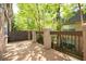Cozy balcony with lush greenery, wooden deck, and charming railing design at 6980 Roswell Rd # N5, Atlanta, GA 30328