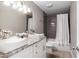 Bathroom features a double sink vanity, granite countertops, and tiled shower at 6980 Roswell Rd # N5, Atlanta, GA 30328