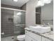 Modern bathroom showcasing tiled shower with glass door and granite countertop vanity at 6980 Roswell Rd # N5, Atlanta, GA 30328