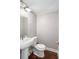 Modern powder room features a sleek pedestal sink and hardwood floors at 6980 Roswell Rd # N5, Atlanta, GA 30328