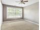 Bright bedroom featuring neutral walls, plush carpeting and a large window at 6980 Roswell Rd # N5, Atlanta, GA 30328