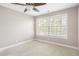 Bright bedroom featuring neutral walls, plush carpeting and a large window at 6980 Roswell Rd # N5, Atlanta, GA 30328