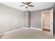 Bedroom with neutral walls, plush carpeting, ceiling fan, and white trim at 6980 Roswell Rd # N5, Atlanta, GA 30328
