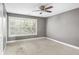 Cozy bedroom with neutral walls, plush carpet, and a bright window at 6980 Roswell Rd # N5, Atlanta, GA 30328