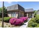 Exterior of the clubhouse beautifully landscaped with vibrant pink azaleas at 6980 Roswell Rd # N5, Atlanta, GA 30328