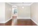Dining room featuring hardwood floors, neutral walls, crown molding and an arched doorway to another room at 6980 Roswell Rd # N5, Atlanta, GA 30328