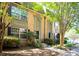 Inviting brick townhome featuring a well-manicured lawn and mature shade trees for a comfortable outdoor living space at 6980 Roswell Rd # N5, Atlanta, GA 30328