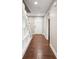 Hallway with hardwood floors and custom shelving under the stairs leading to front door at 6980 Roswell Rd # N5, Atlanta, GA 30328