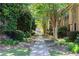 Community walkway lined with lush trees, leading to residences at 6980 Roswell Rd # N5, Atlanta, GA 30328