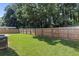Spacious backyard area with a wood fence and lush green lawn at 802 Cormac Dr, Riverdale, GA 30296