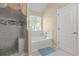 Nicely tiled bathroom with glass enclosed shower and separate soaking tub under a window at 802 Cormac Dr, Riverdale, GA 30296