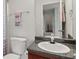 Well-lit bathroom with a gray granite countertop, white sink, and vanity at 802 Cormac Dr, Riverdale, GA 30296