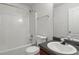 Cozy bathroom with a combined bathtub and shower with a large vanity and sink at 802 Cormac Dr, Riverdale, GA 30296
