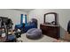 Bedroom featuring a large bed, dark wood dresser, and cozy beanbag chair at 802 Cormac Dr, Riverdale, GA 30296