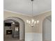 View of dining room with chandelier, looking toward the living room with fireplace at 802 Cormac Dr, Riverdale, GA 30296