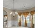 Elegant dining room with chair rail and gold patterned curtains, and decorative ceiling at 802 Cormac Dr, Riverdale, GA 30296