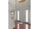 Bright entryway featuring hardwood floors, staircase, and a white front door at 802 Cormac Dr, Riverdale, GA 30296