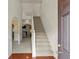 Bright entryway featuring hardwood floors, staircase, and views to adjacent living spaces at 802 Cormac Dr, Riverdale, GA 30296
