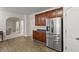 View of the kitchen with stainless steel refrigerator, and hardwood floors at 802 Cormac Dr, Riverdale, GA 30296