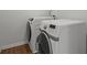 Modern white front-loading washer and dryer with wooden floor at 802 Cormac Dr, Riverdale, GA 30296