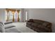 Bright living room with large windows, plush sofas, and neutral walls and carpet at 802 Cormac Dr, Riverdale, GA 30296