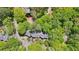 Aerial shot of the property reveals homes nestled amidst lush greenery and mature trees at 171 Riverview Trl, Roswell, GA 30075