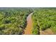 Scenic aerial view of a tranquil river flowing through a lush green forest, offering a serene and natural backdrop at 171 Riverview Trl, Roswell, GA 30075