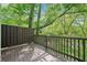 The backyard deck is surrounded by tall, mature trees creating a peaceful outdoor space at 171 Riverview Trl, Roswell, GA 30075