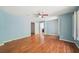 Large bedroom with hardwood floors, ceiling fan, blue walls, and plantation shutters on the windows at 171 Riverview Trl, Roswell, GA 30075