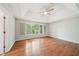 Primary bedroom with hardwood floors, vaulted ceiling and a large window at 171 Riverview Trl, Roswell, GA 30075