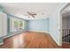 Spacious bedroom with hardwood floors, ceiling fan, plantation shutters, and freshly painted walls at 171 Riverview Trl, Roswell, GA 30075
