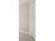 Corner of a bedroom with neutral carpet and light-colored walls and trim, as well as a door at 171 Riverview Trl, Roswell, GA 30075