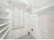Walk-in closet featuring custom shelving and a window for natural light at 171 Riverview Trl, Roswell, GA 30075